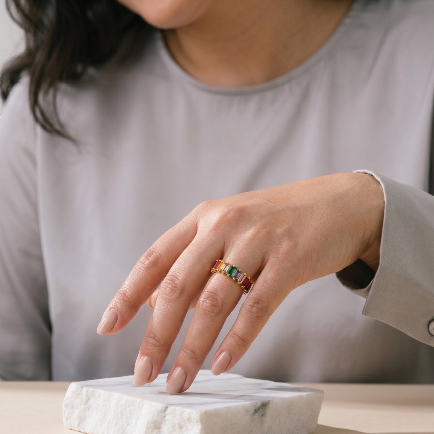 Chévereh adjustable gold-tone stainless steel ring featuring rainbow baguette-cut cubic zirconia stones on a model.