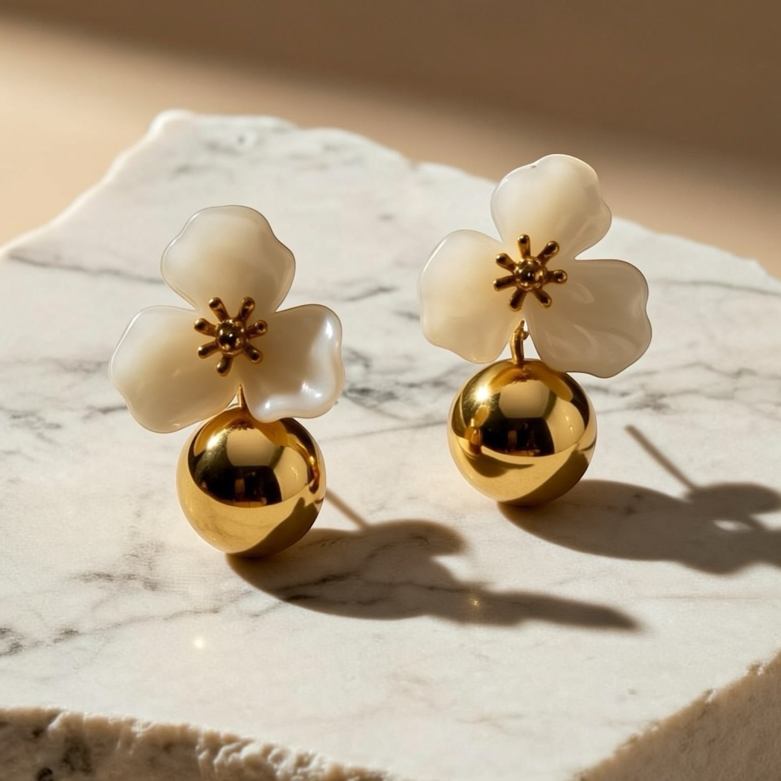 Chévereh beige hibiscus floral ball drop earrings with gold centers and polished gold balls.