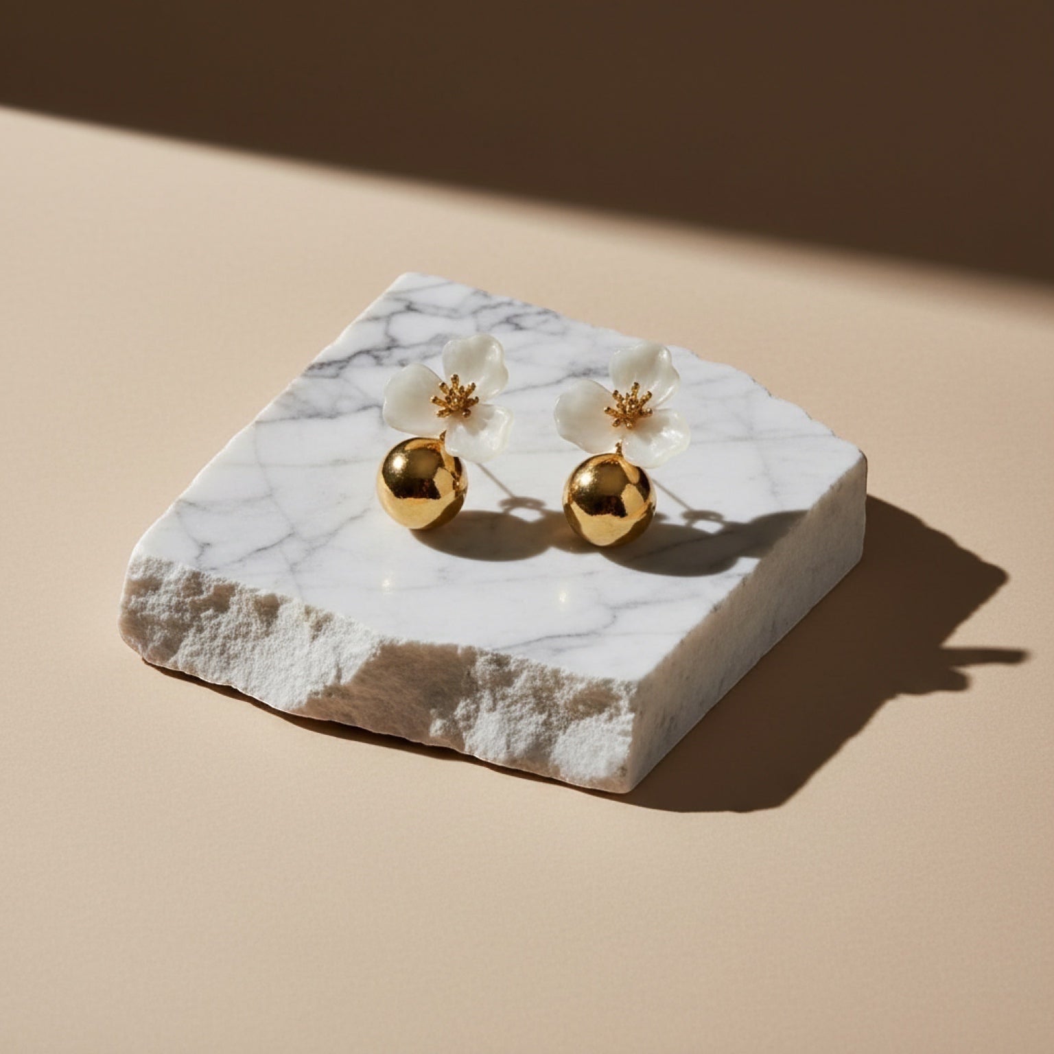 Chévereh beige hibiscus floral ball drop earrings with gold centers and polished gold ball charms.