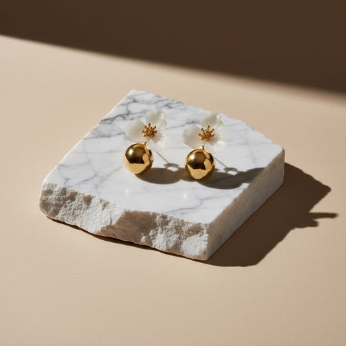 Chévereh beige hibiscus floral ball drop earrings with gold centers and polished gold ball charms.