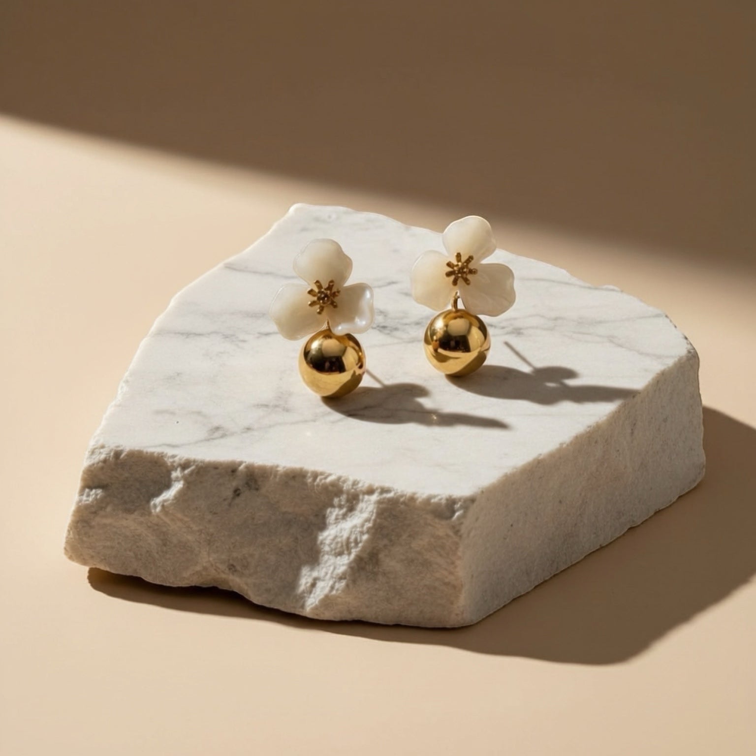 Chévereh beige hibiscus floral drop earrings with gold ball charms, 18K gold plated stainless steel.