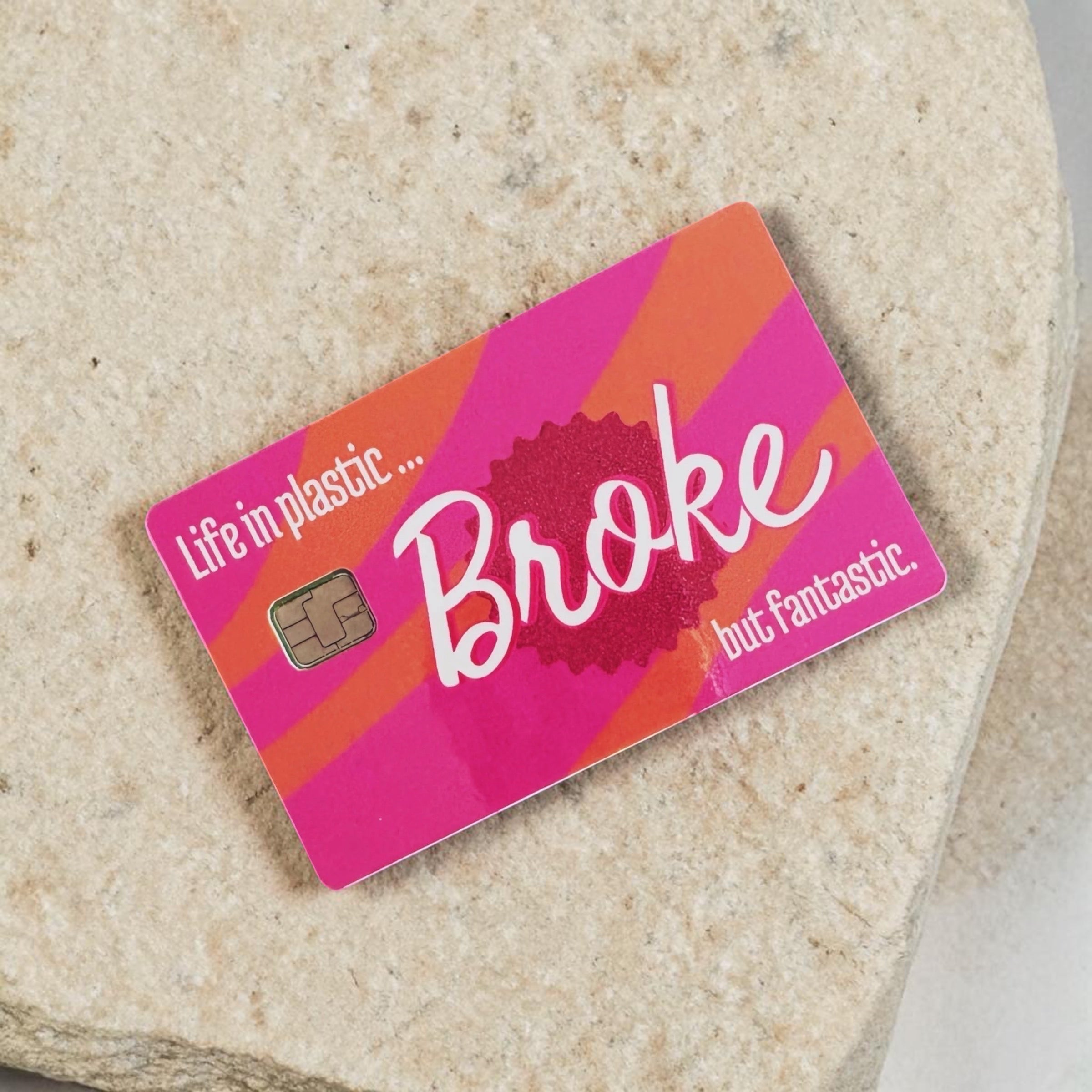 Chévereh waterproof debit and credit card skin with pink and orange stripes and "Life in plastic... Broke but fantastic" text.