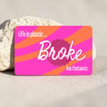 Chévereh waterproof debit and credit card skin with pink and orange stripes and "Life in plastic... Broke but fantastic" text.