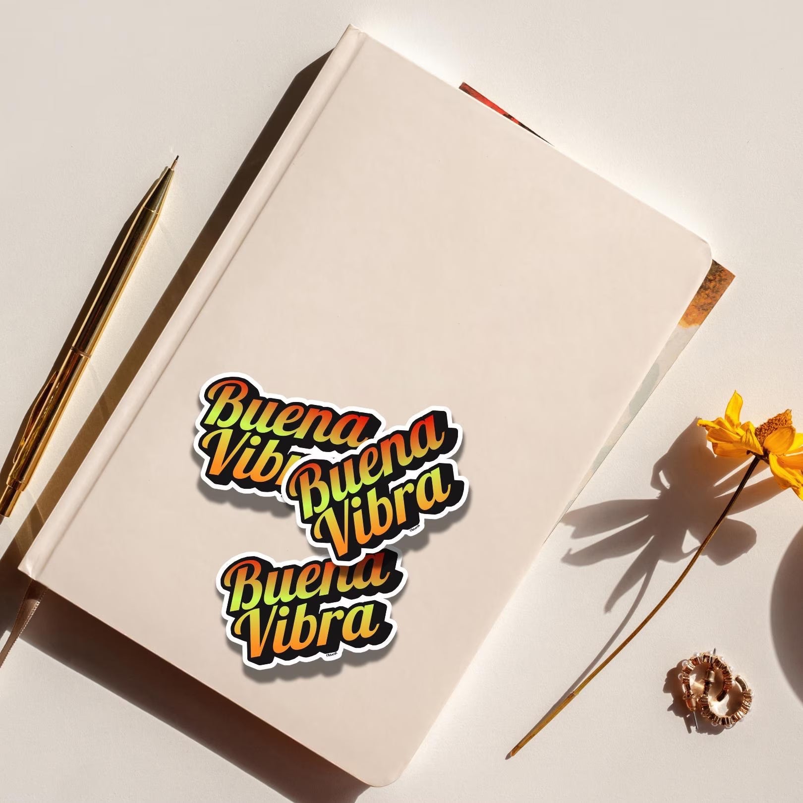 Chévereh Buena Vibra gradient vinyl sticker with glossy finish on a notebook.