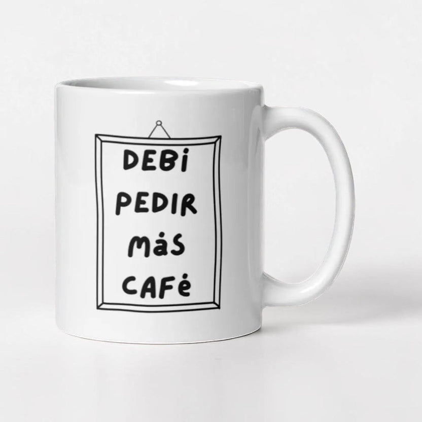 Chévereh white ceramic mug with black text that reads "Debí Pedir Más Café" in a framed design.