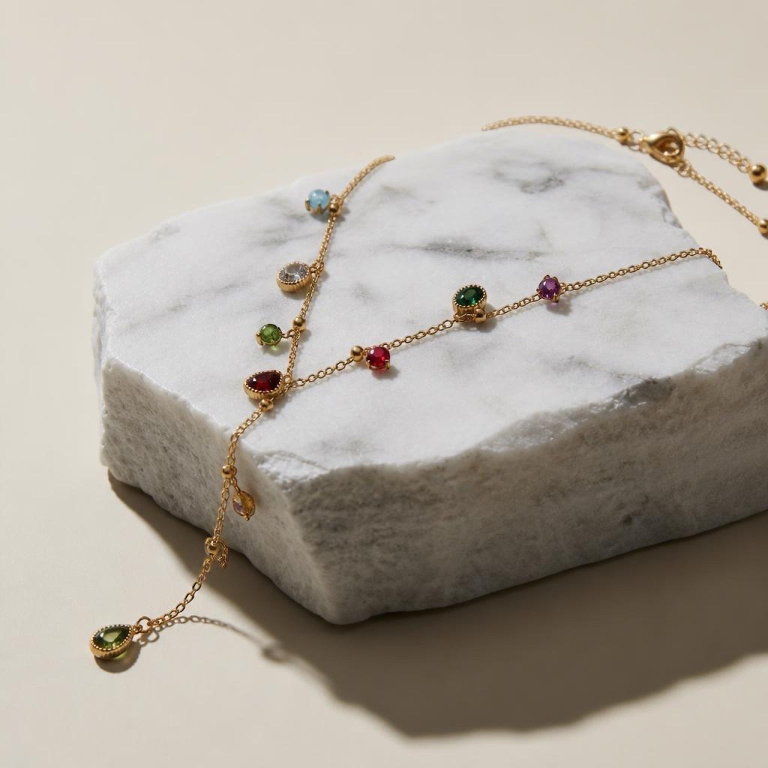 Chévereh dainty gold-tone stainless steel necklace featuring a delicate chain with colorful multifaceted drop stones.