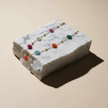 Chévereh floral beaded chain necklace with colorful flower-shaped beads and gold spheres on a delicate gold-tone chain.