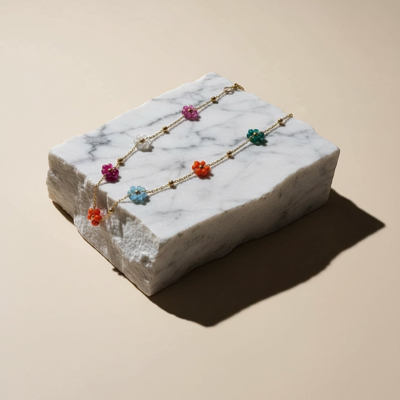 Chévereh floral beaded chain necklace with colorful flower-shaped beads and gold spheres on a delicate gold-tone chain.