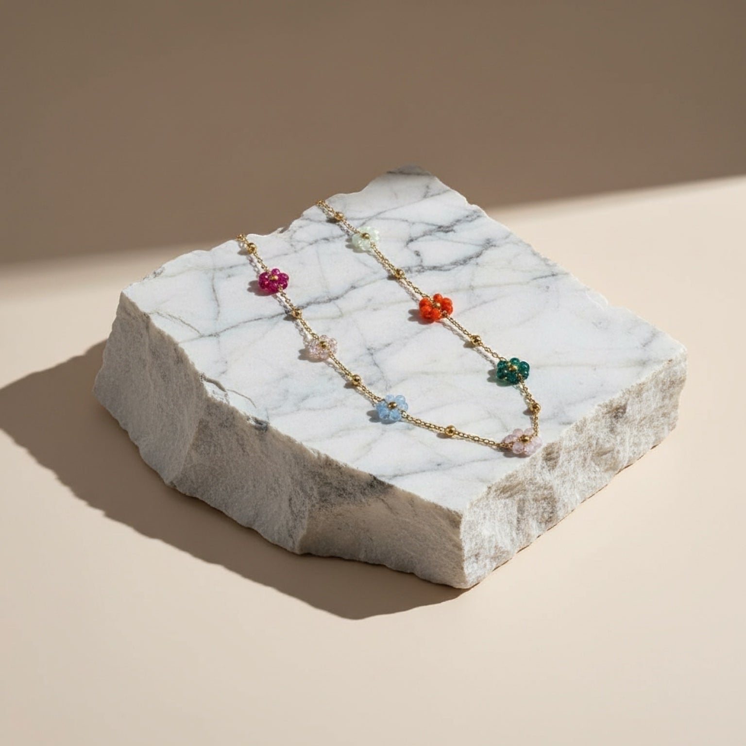 Chévereh gold-tone chain necklace with colorful floral beads in pink, blue, green, orange, and clear.