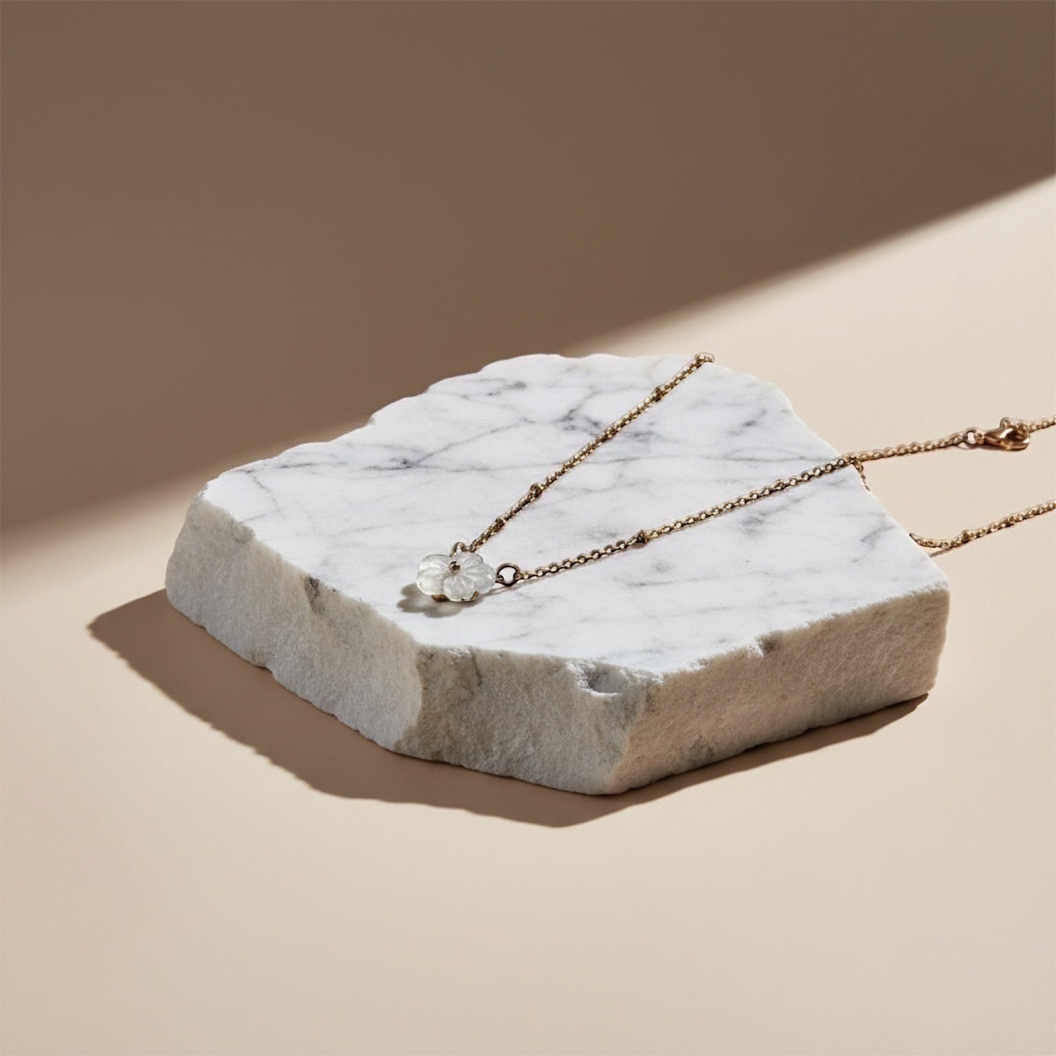 Chévereh delicate mother-of-pearl flower pendant necklace with gold-tone chain and tiny beads.