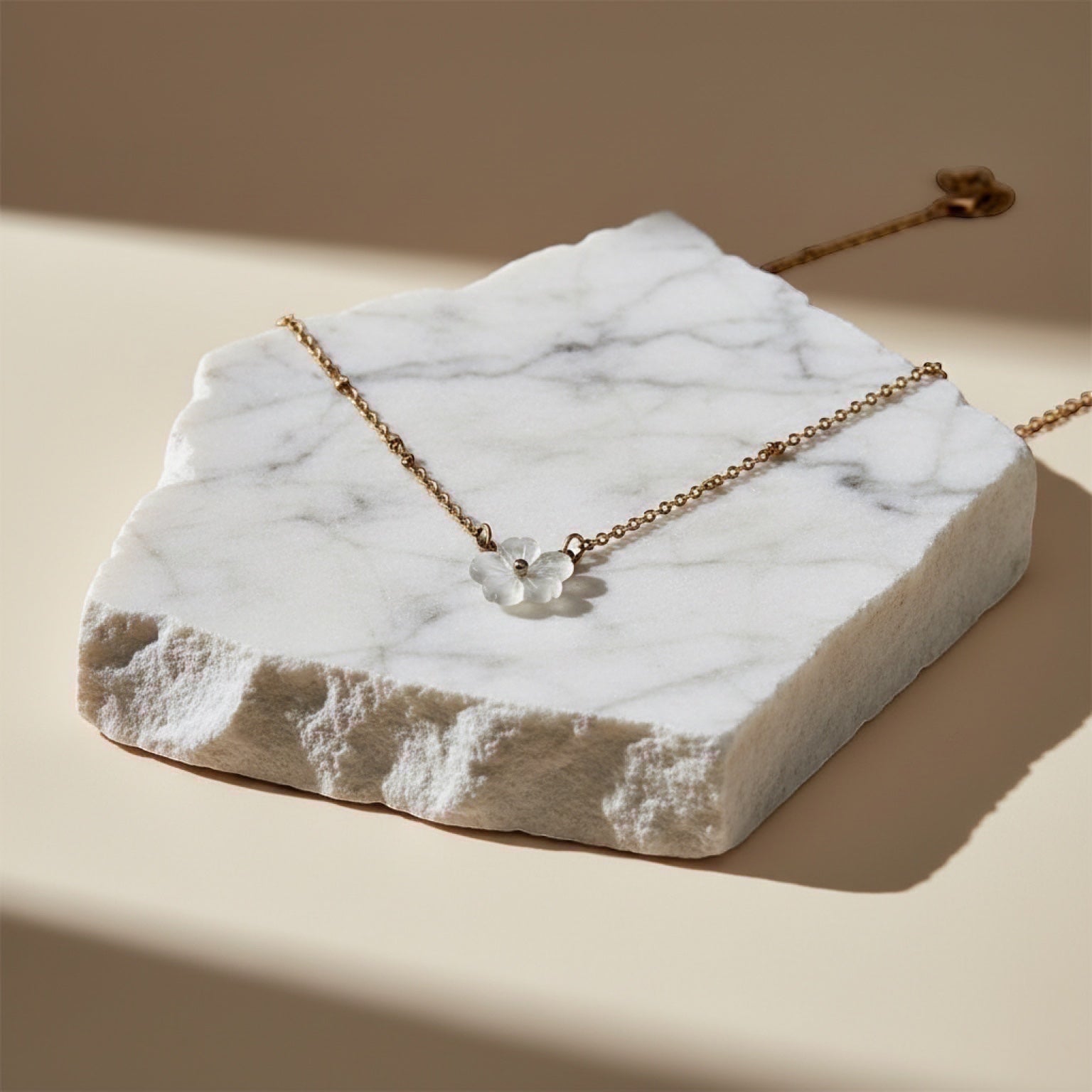 Chévereh delicate mother-of-pearl flower pendant necklace with gold-tone chain and tiny beads.