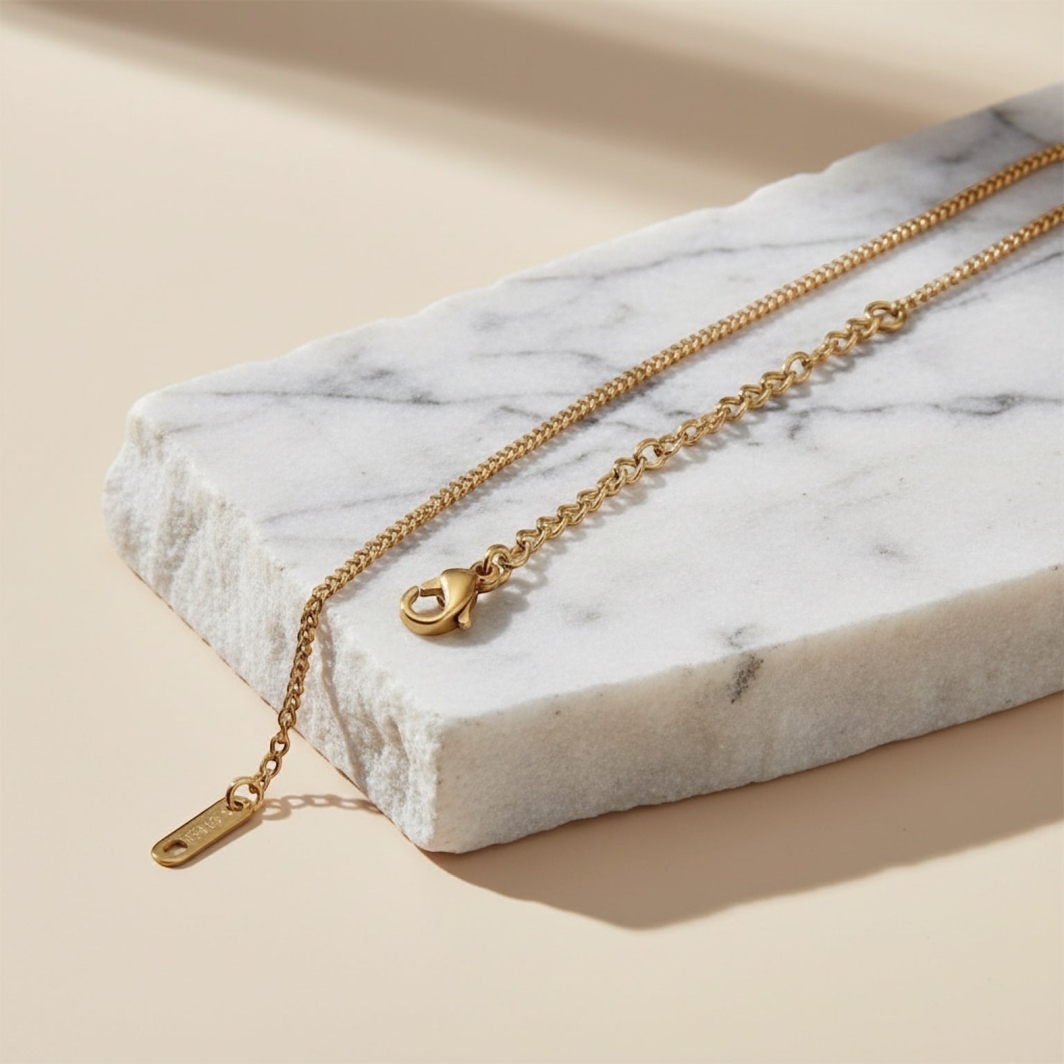 Chévereh gold-tone Greca necklace with a delicate chain and lobster clasp, inspired by Italian coffee makers.