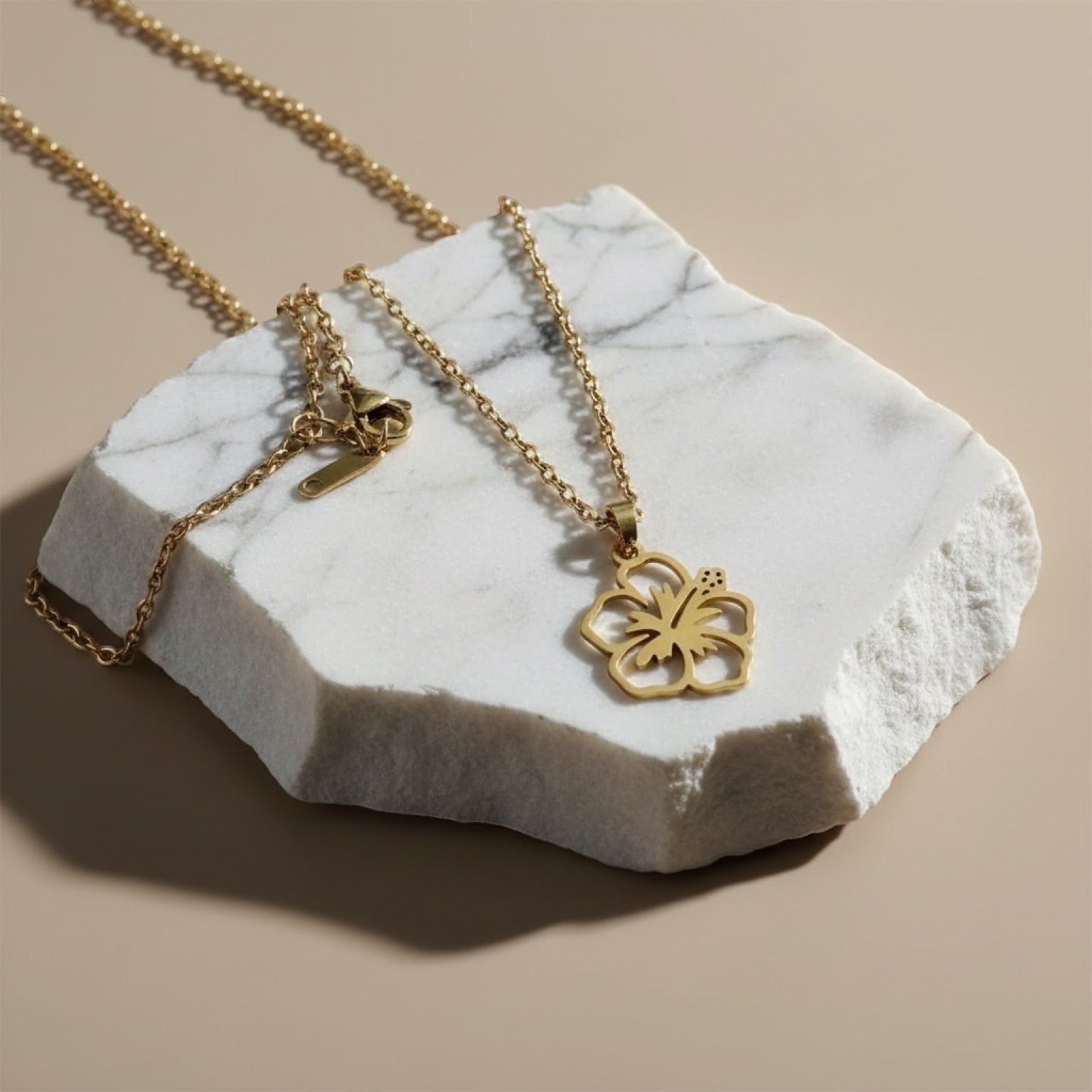 Chévereh gold-tone maga flower pendant necklace with a delicate chain. Minimalist floral design.