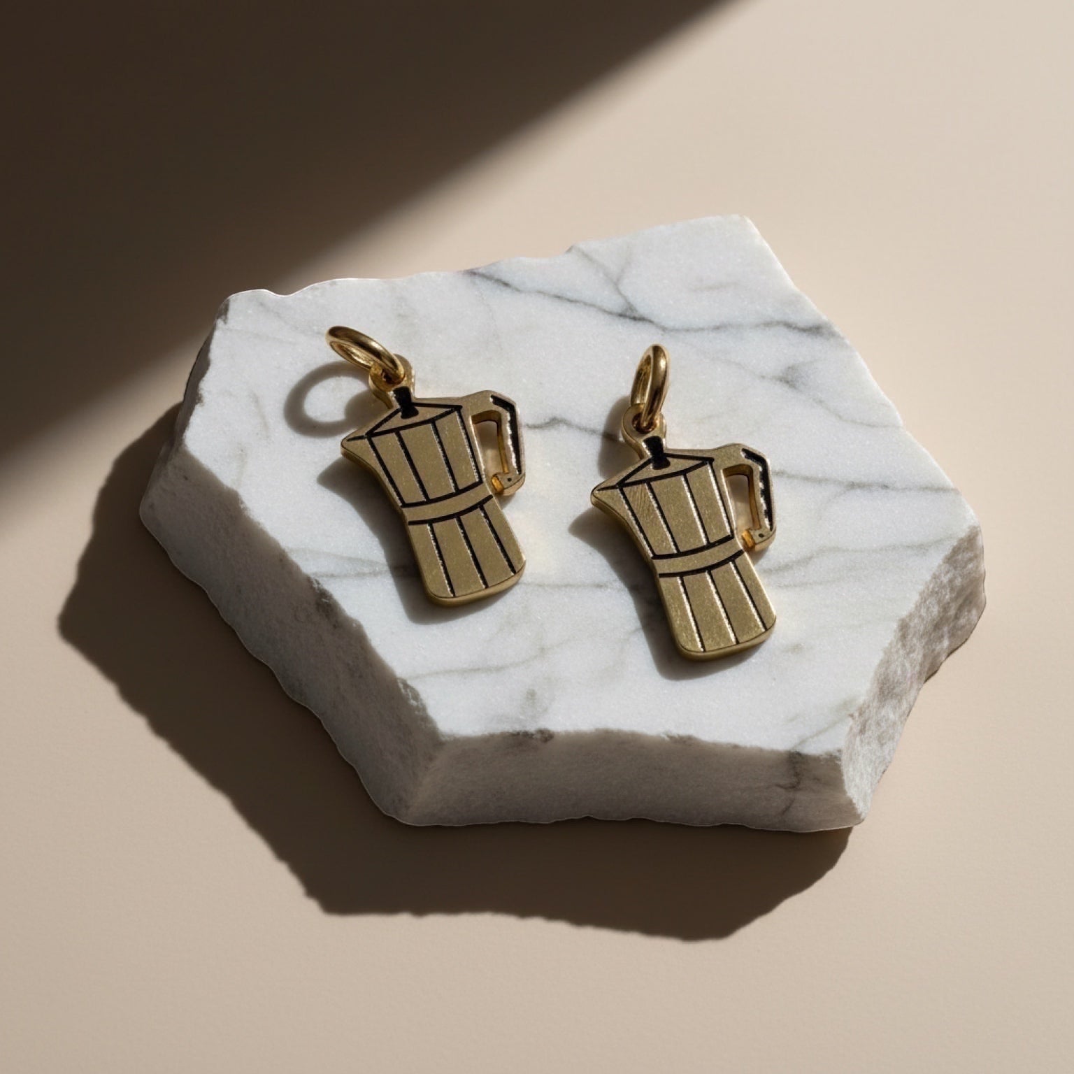 Chévereh gold-tone metal Greca charm necklace shaped like a moka pot, with black detailing.