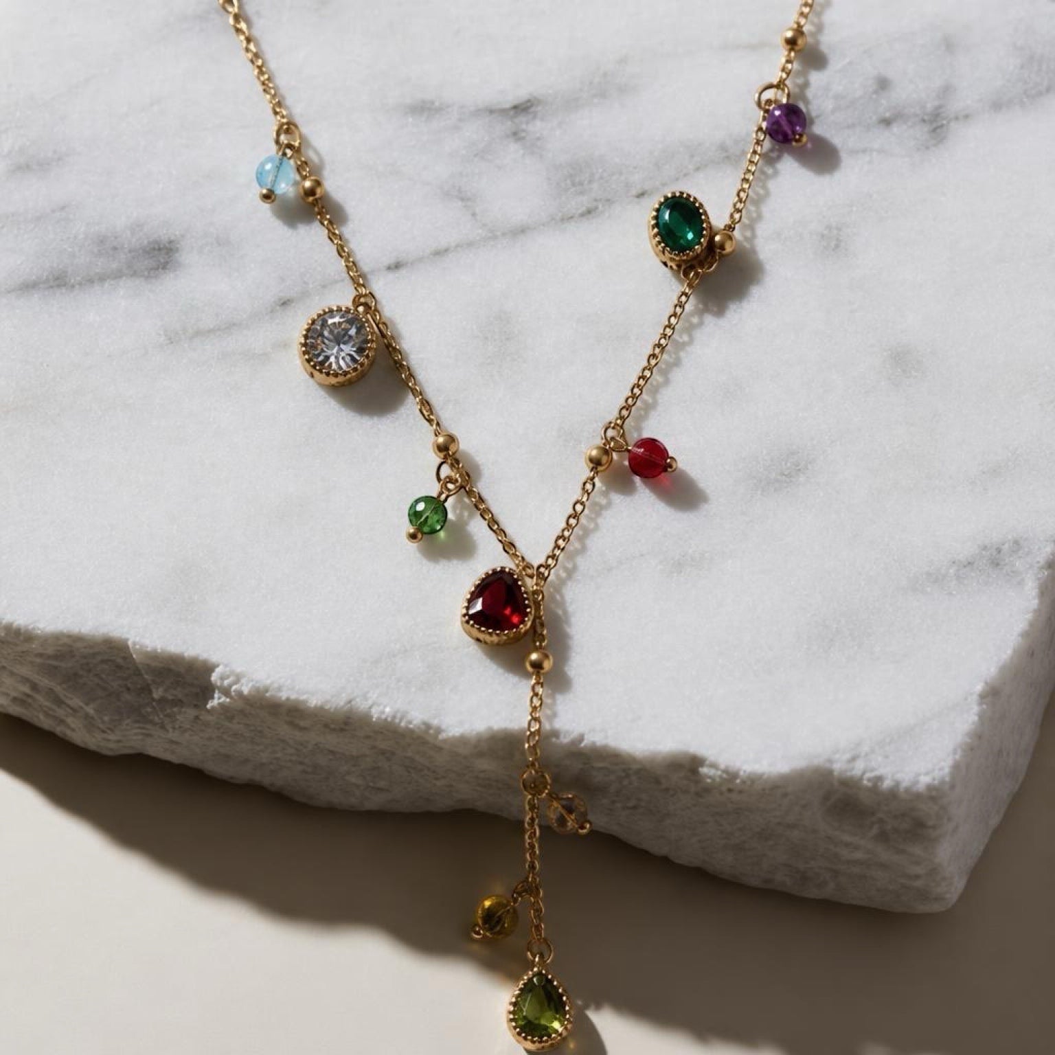 Chévereh dainty gold-tone stainless steel necklace featuring a drop pendant with colorful multifaceted gemstones.