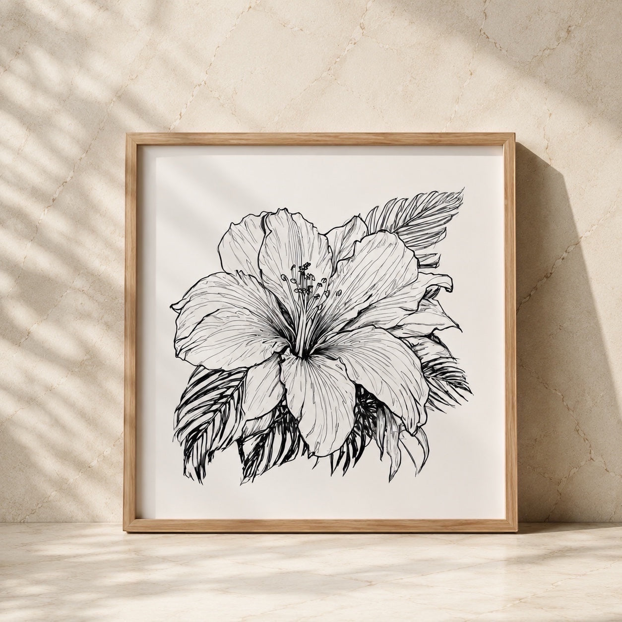 Chévereh black and white hibiscus line art print in a light wood frame against a textured beige wall.