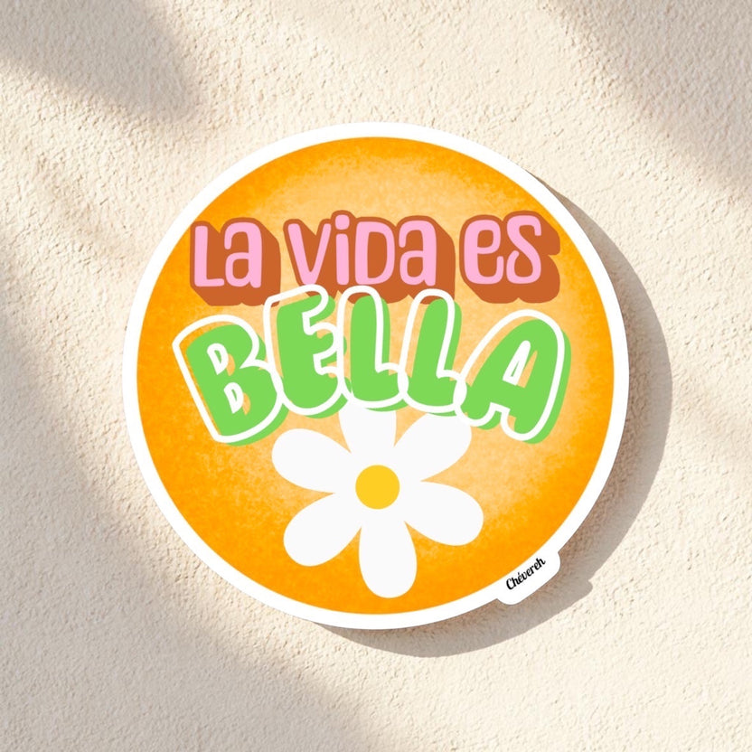Chévereh La Vida Es Bella vinyl sticker with orange background, green lettering, and white flower detail.