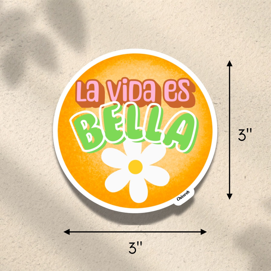 Chévereh La Vida Es Bella vinyl sticker with orange background, green lettering, and white flower detail. Waterproof, glossy finish.