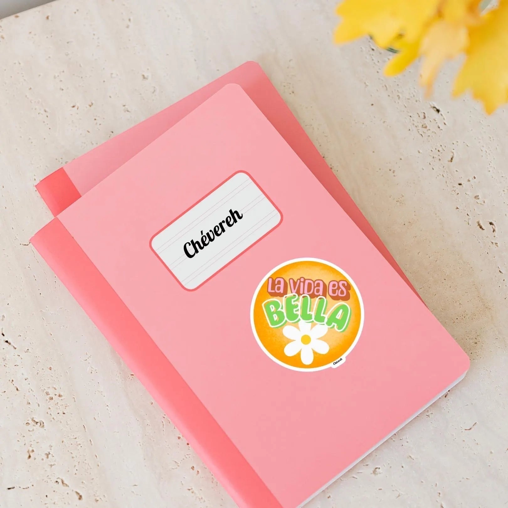 Chévereh La Vida Es Bella waterproof vinyl sticker with orange background, white flower, and playful lettering.
