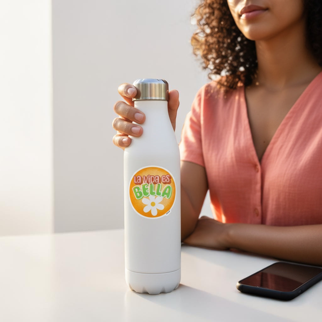 Chévereh La vida es Bella vinyl sticker with orange background, playful lettering, and a white flower detail. Waterproof and glossy.