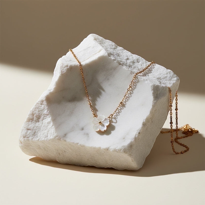 Chévereh delicate mother-of-pearl flower pendant necklace with gold-tone chain and beaded accents.