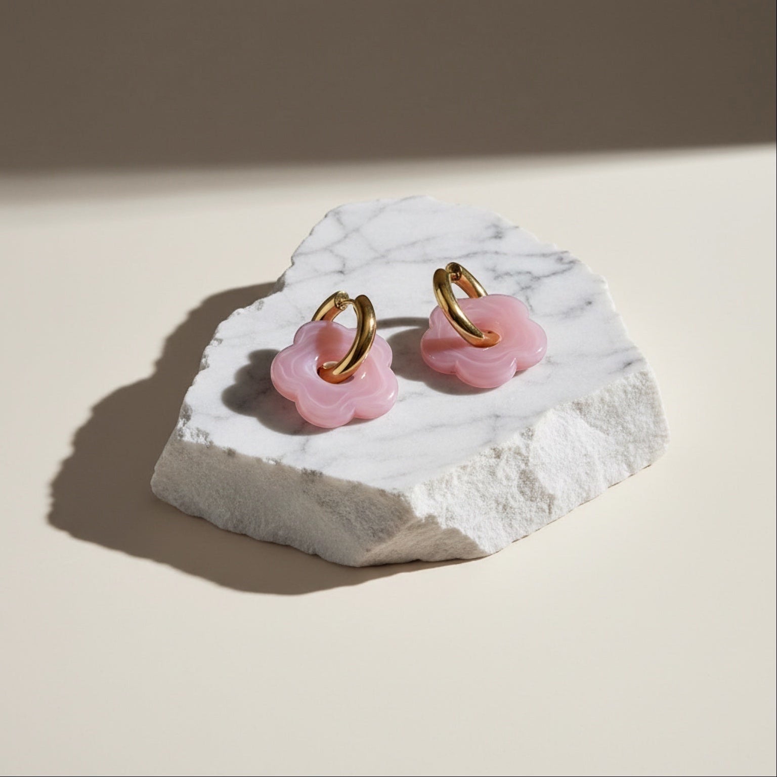 Chévereh pink translucent flower drop hoop earrings with gold-tone metal.
