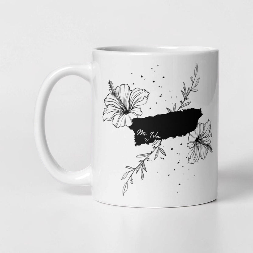 Chévereh Island Vibes white ceramic mug with black Puerto Rico outline, hibiscus flowers, and leaves. Reads 'Mi Isla'.