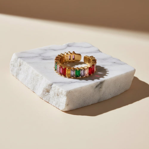 Chévereh adjustable gold-tone open-cuff ring with rainbow baguette-cut cubic zirconia stones.