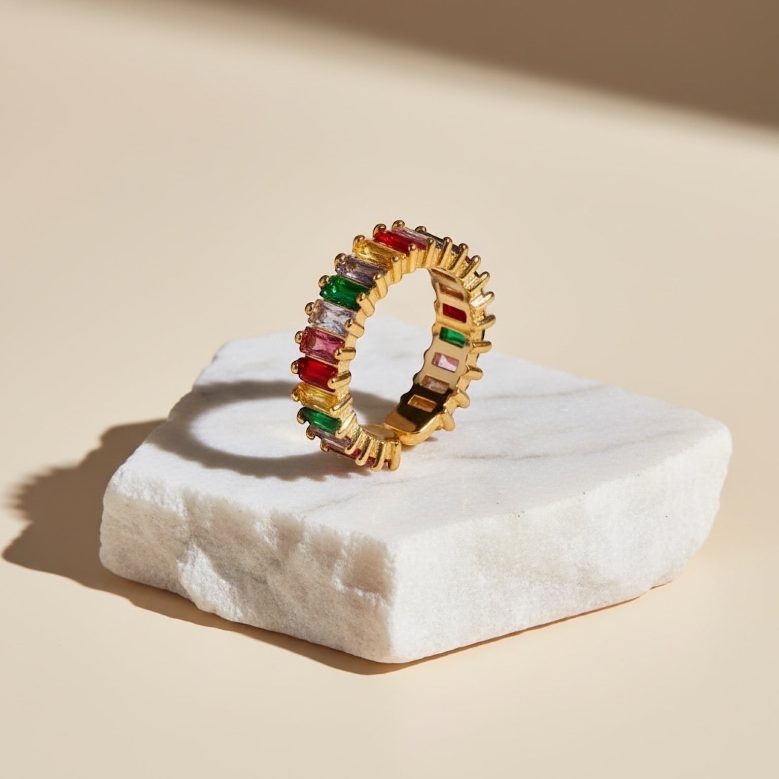 Chévereh gold-tone adjustable ring with rainbow baguette-cut cubic zirconia stones.
