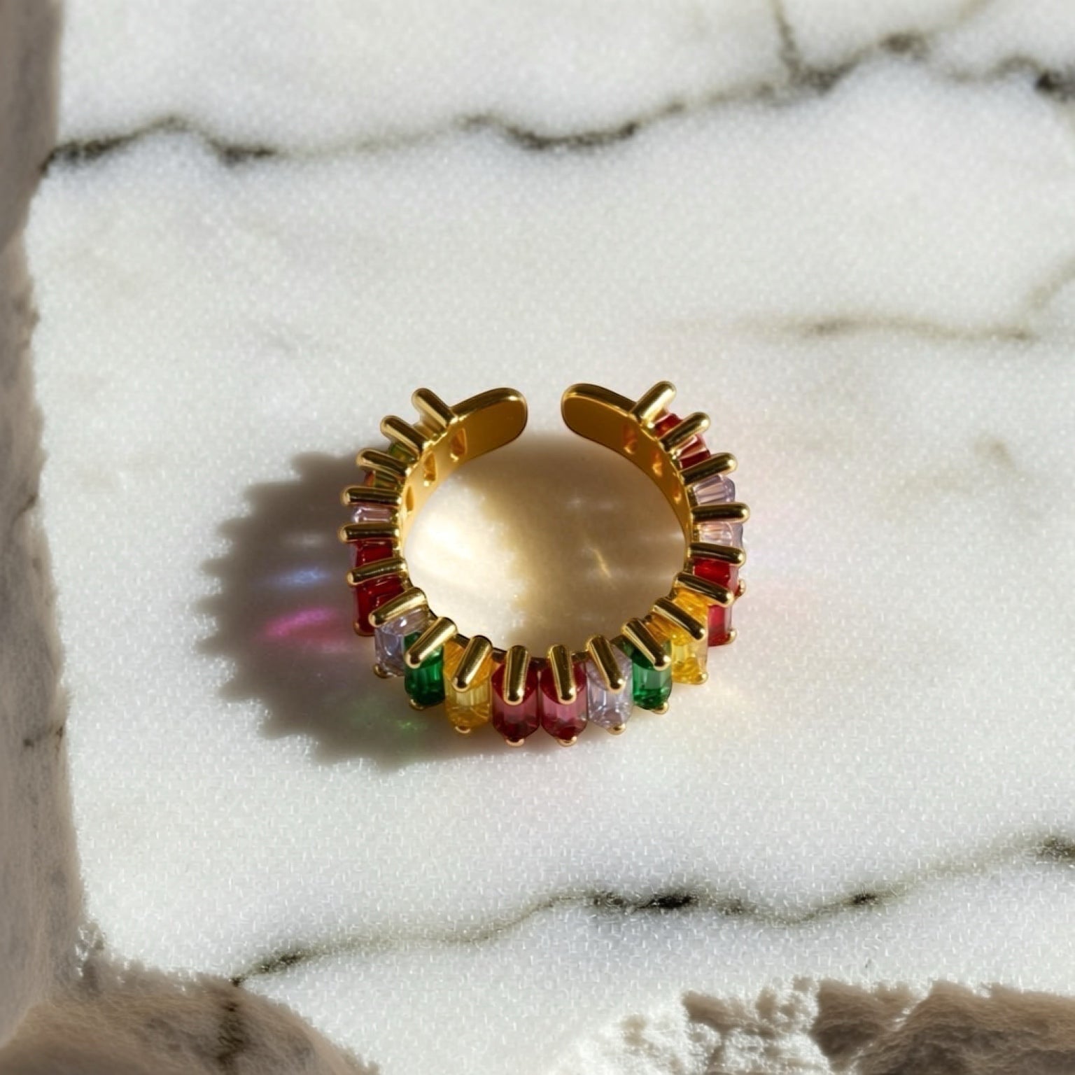 Chévereh gold-tone adjustable ring with rainbow baguette-cut cubic zirconia stones.