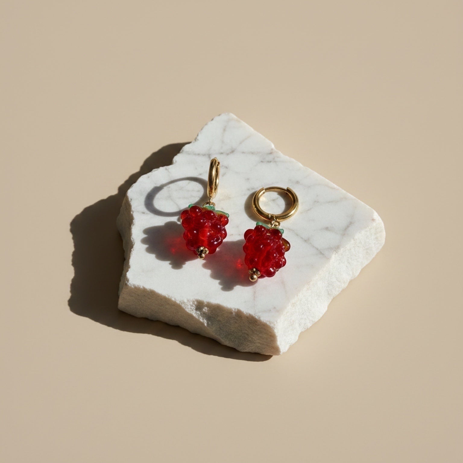Chévereh Raspberry Glass Drop Earrings with red beads, green accents, and gold hoops.