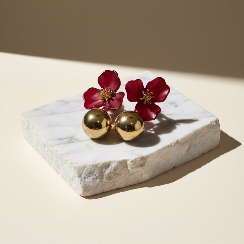 Chévereh red hibiscus floral ball drop earrings with gold centers and polished gold balls.