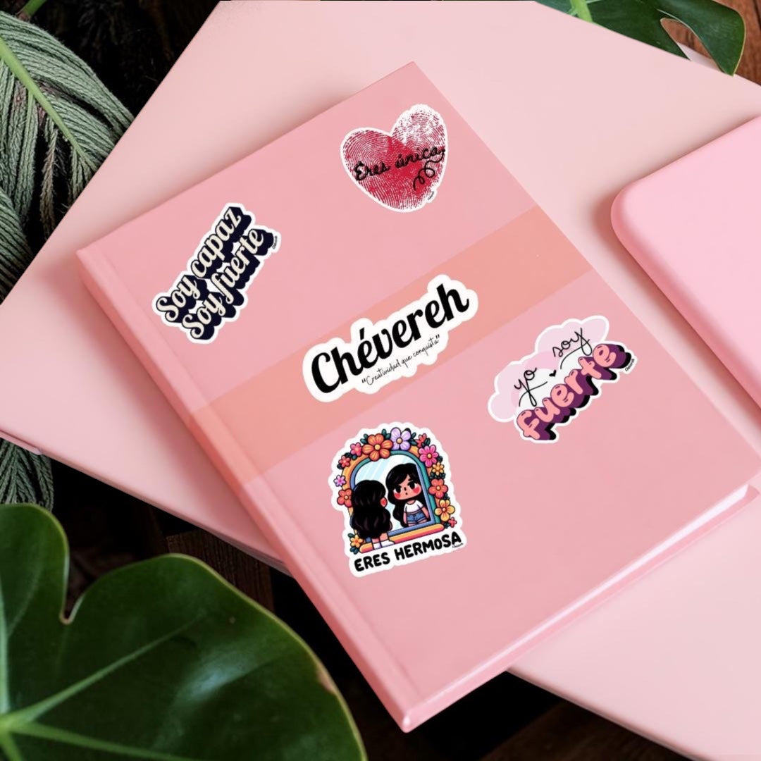 Chévereh glossy vinyl stickers with Spanish affirmations on a pink journal, featuring Latina-inspired floral designs.