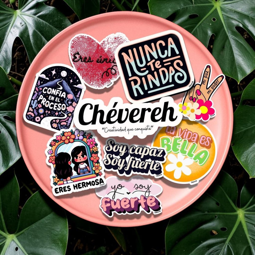 Chévereh glossy vinyl sticker pack with Latina-themed Spanish affirmations on a pink plate over green leaves.