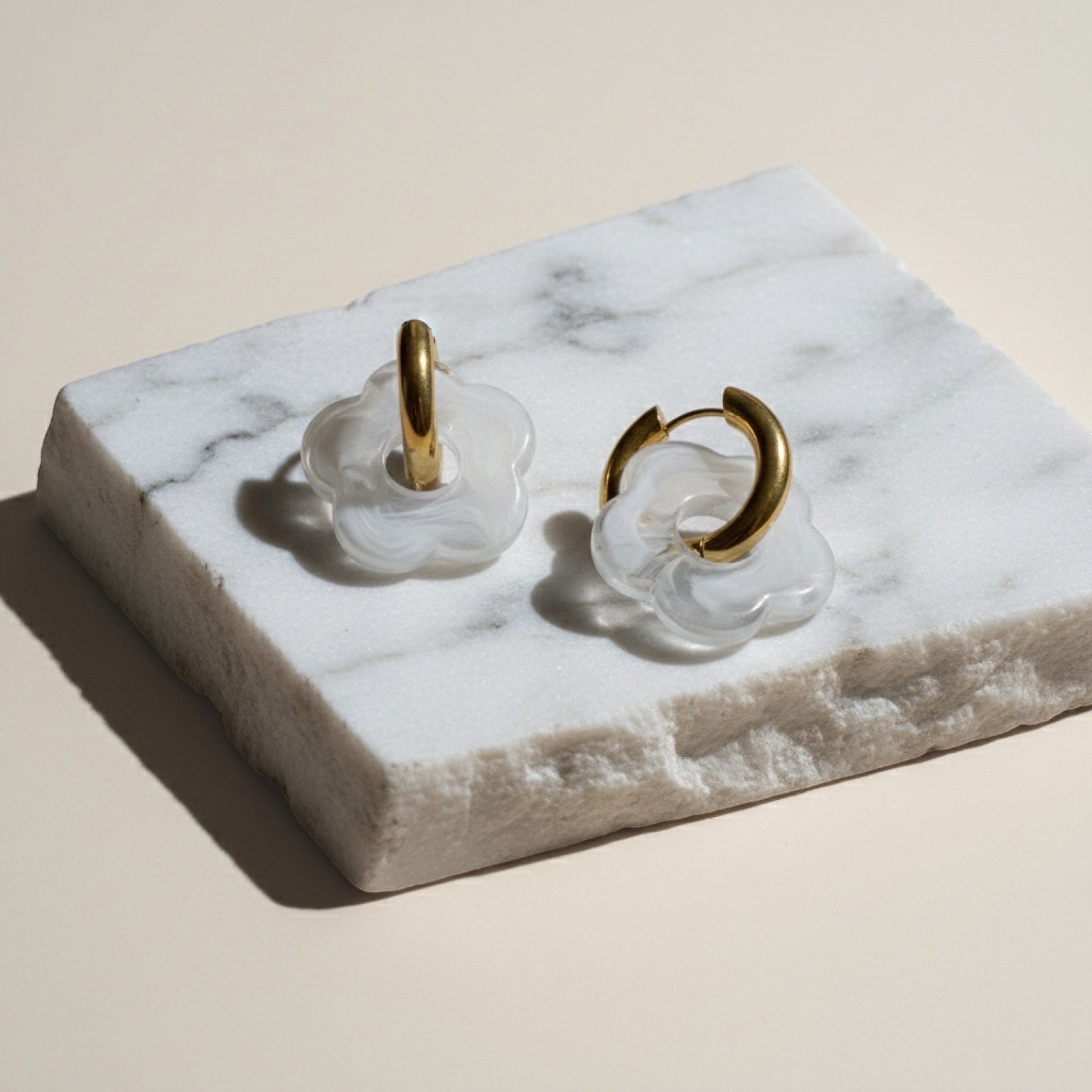 Chévereh White Bloom & Gold abstract flower drop earrings with gold hoops and milky white charms.