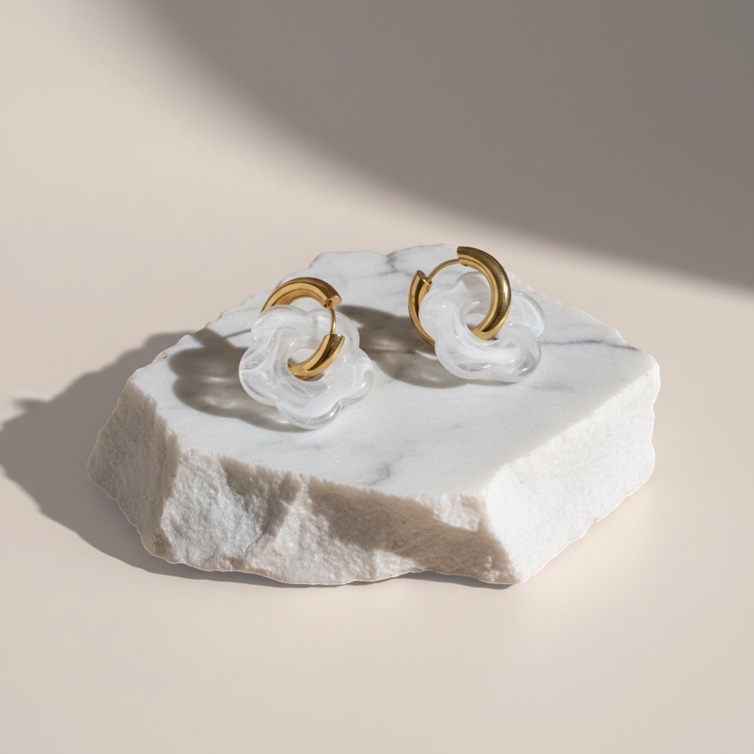 Chévereh White Bloom & Gold abstract flower drop earrings with gold hoops and milky white translucent charms.
