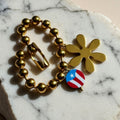 Chévereh gold-tone beaded bracelet with flower and Puerto Rico flag charms.